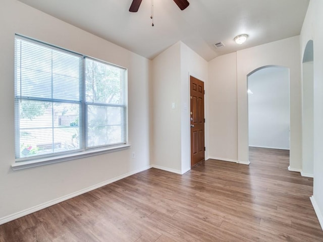 131 Freedom Trl, Forney, TX 75126 - spare room with arched walkways, plenty of natural light, a ceiling fan, wood finished floors, and lofted ceiling