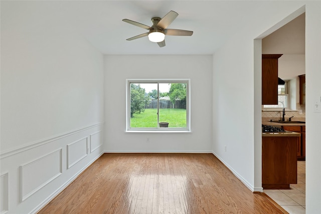 1645 Ashbourne Dr, Rockwall, TX 75087 - empty room featuring a ceiling fan and light wood-style flooring
