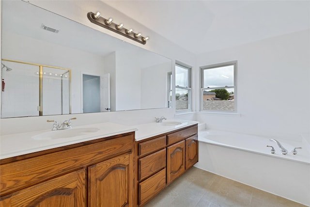 1645 Ashbourne Dr, Rockwall, TX 75087 - bathroom featuring double vanity, a bath, a shower stall, and tile patterned floors