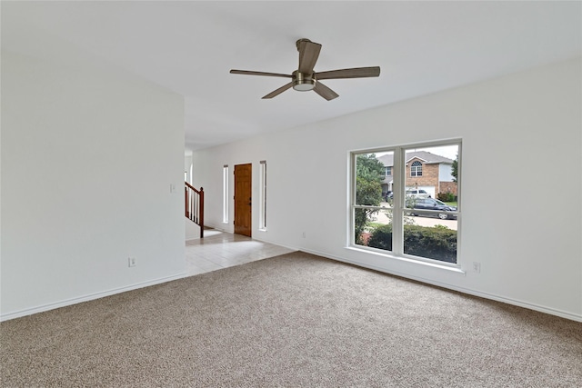 1645 Ashbourne Dr, Rockwall, TX 75087 - unfurnished room with light carpet, ceiling fan, stairs, and light tile patterned flooring
