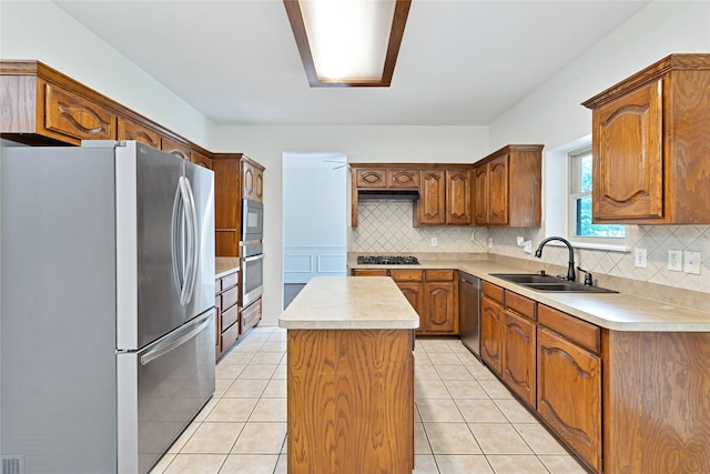1645 Ashbourne Dr, Rockwall, TX 75087 - kitchen featuring appliances with stainless steel finishes, a kitchen island, backsplash, and light countertops