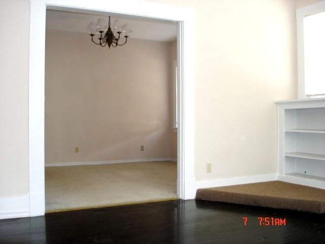 111 N Winnetka Ave, Dallas, TX 75208 - empty room with a chandelier and baseboards
