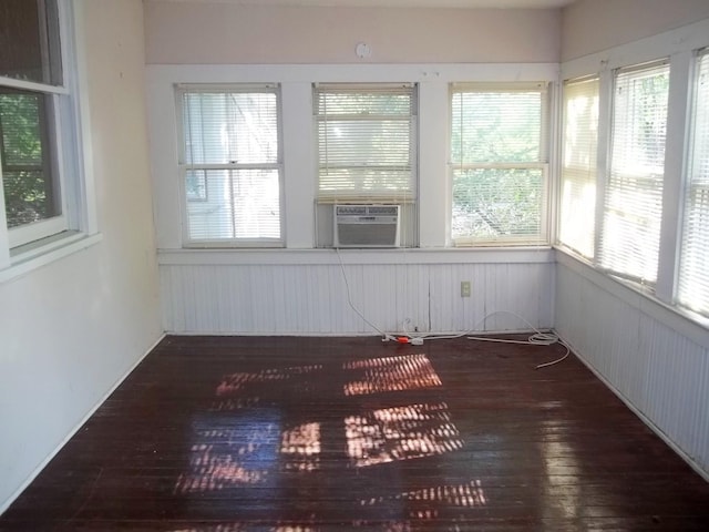 111 N Winnetka Ave, Dallas, TX 75208 - unfurnished sunroom featuring hardwood / wood-style floors, a wainscoted wall, cooling unit, plenty of natural light, and wood walls