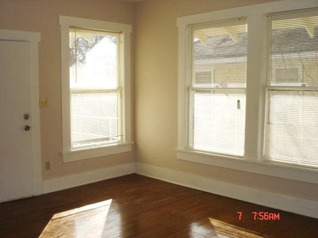 111 N Winnetka Ave, Dallas, TX 75208 - spare room featuring dark wood-type flooring and baseboards