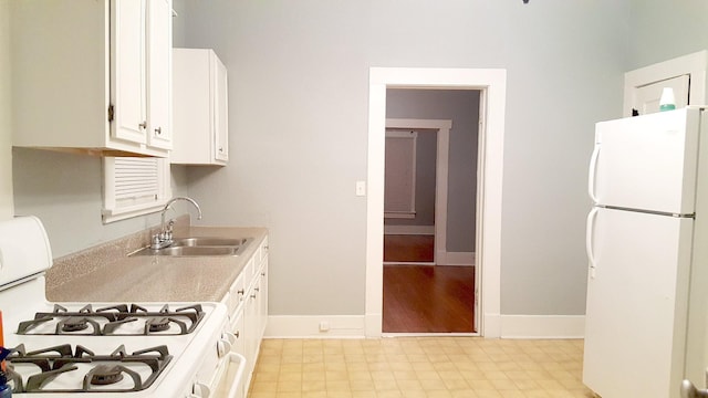 111 N Winnetka Ave, Dallas, TX 75208 - kitchen with white appliances, white cabinets, and light countertops