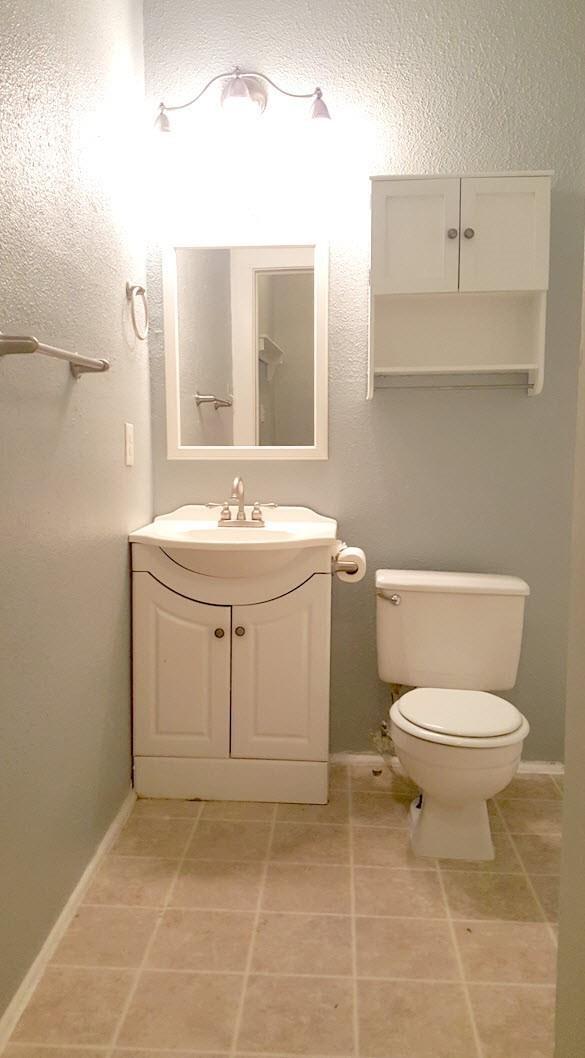 111 N Winnetka Ave, Dallas, TX 75208 - half bathroom featuring vanity and tile patterned flooring