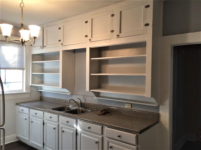 111 N Winnetka Ave, Dallas, TX 75208 - kitchen featuring open shelves, a chandelier, and white cabinetry