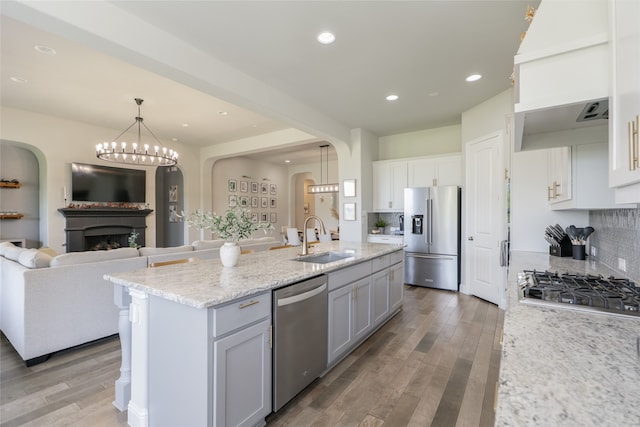 1253 Gray Fox Ln, Frisco, TX 75033 - kitchen with appliances with stainless steel finishes, arched walkways, open floor plan, decorative backsplash, and recessed lighting