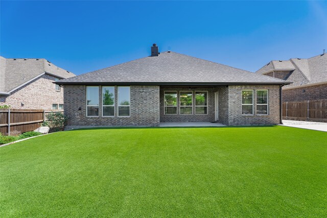 1253 Gray Fox Ln, Frisco, TX 75033 - rear view of property featuring a fenced backyard, brick siding, a chimney, a patio, and roof with shingles