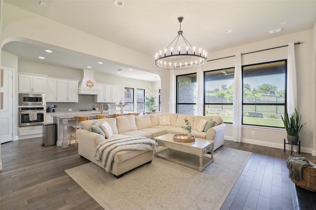 1253 Gray Fox Ln, Frisco, TX 75033 - living room with a chandelier, dark wood finished floors, arched walkways, and recessed lighting