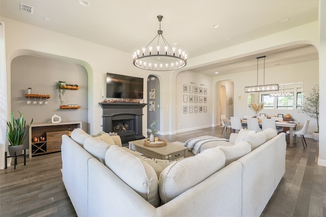 1253 Gray Fox Ln, Frisco, TX 75033 - living area featuring arched walkways, a chandelier, a fireplace, wood finished floors, and recessed lighting