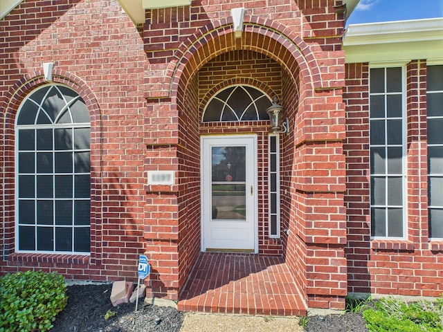 1197 Pleasant Oaks Dr, Lewisville, TX 75067 - view of exterior entry featuring brick siding