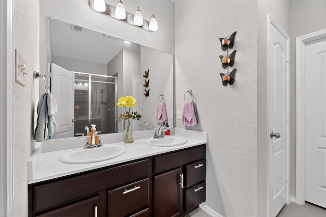 1712 Intervale Rd, Providence Village, TX 76227 - bathroom featuring double vanity, a shower stall, and a textured wall