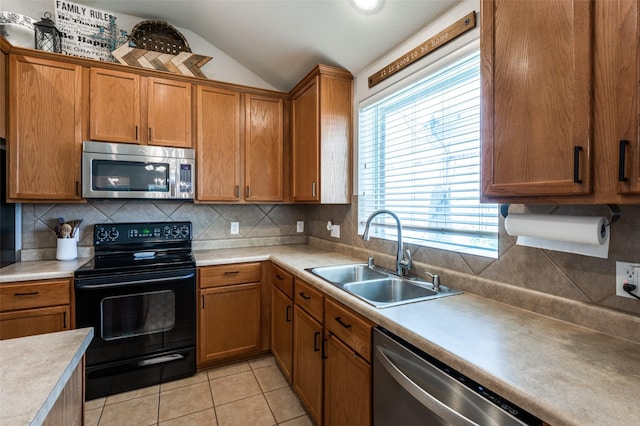 109 Niagara Falls Dr, Anna, TX 75409 - kitchen with stainless steel appliances, vaulted ceiling, light countertops, light tile patterned floors, and tasteful backsplash