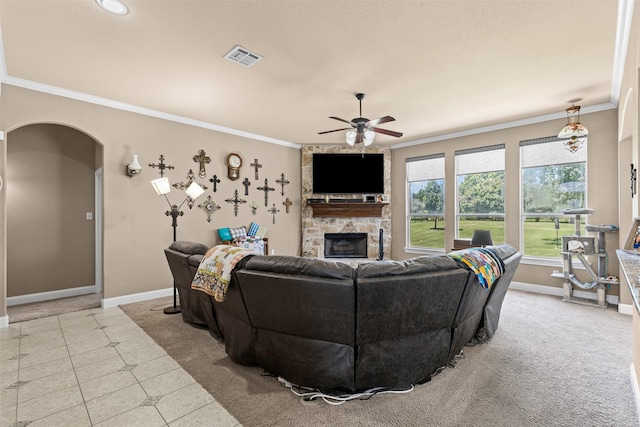 5024 Running Brook Dr, Joshua, TX 76058 - living room featuring crown molding, a fireplace, ceiling fan, arched walkways, and tile patterned floors