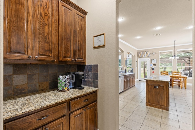 5024 Running Brook Dr, Joshua, TX 76058 - kitchen featuring stainless steel dishwasher, arched walkways, decorative backsplash, crown molding, and light tile patterned floors