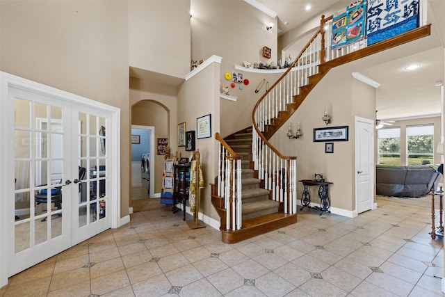 5024 Running Brook Dr, Joshua, TX 76058 - staircase featuring a towering ceiling, crown molding, french doors, a ceiling fan, and tile patterned floors