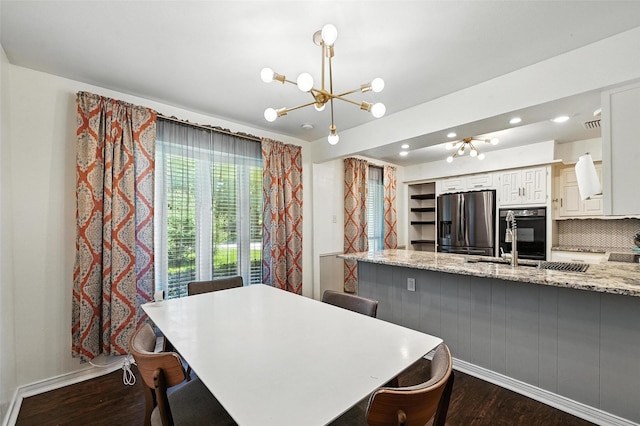 826 E Cherry St, Duncanville, TX 75116 - dining room featuring a chandelier, dark wood-style floors, and recessed lighting