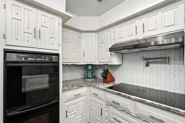 826 E Cherry St, Duncanville, TX 75116 - kitchen with black appliances, under cabinet range hood, backsplash, and white cabinets