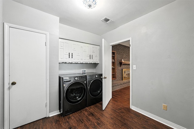 826 E Cherry St, Duncanville, TX 75116 - washroom featuring washer and dryer, cabinet space, and dark wood-type flooring