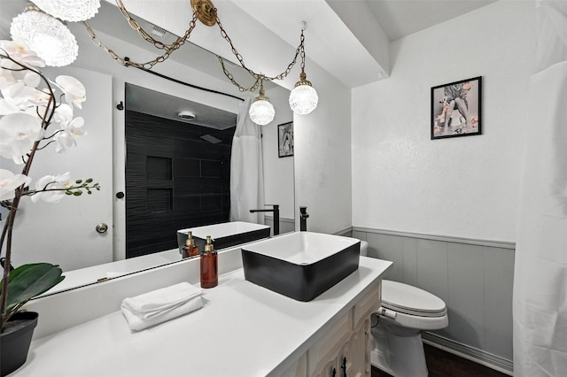 826 E Cherry St, Duncanville, TX 75116 - bathroom featuring vanity, a wainscoted wall, curtained shower, wood finished floors, and a decorative wall