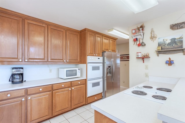 110 Waterview Ln, Pottsboro, TX 75076 - kitchen featuring white appliances, light countertops, brown cabinets, and light tile patterned floors