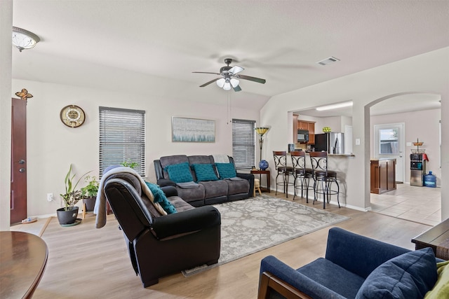 1420 Arabella Ave, Forney, TX 75126 - living room with arched walkways, a ceiling fan, and light wood-style floors