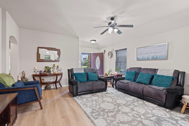 1420 Arabella Ave, Forney, TX 75126 - living room featuring light wood-style floors, a ceiling fan, and arched walkways