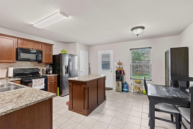 1420 Arabella Ave, Forney, TX 75126 - kitchen featuring black appliances, a kitchen island, backsplash, a textured ceiling, and light tile patterned floors