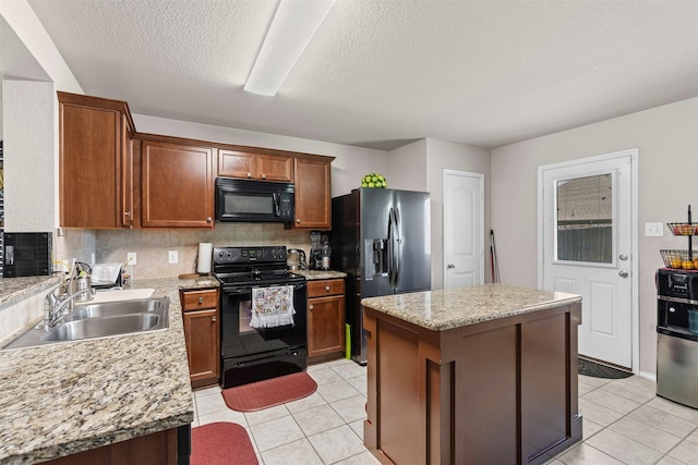 1420 Arabella Ave, Forney, TX 75126 - kitchen featuring black appliances, a center island, light tile patterned floors, tasteful backsplash, and a textured ceiling