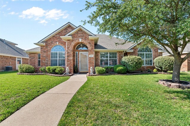 4611 Harvest Ln, Sachse, TX 75048 - traditional-style house featuring a front lawn, brick siding, and roof with shingles