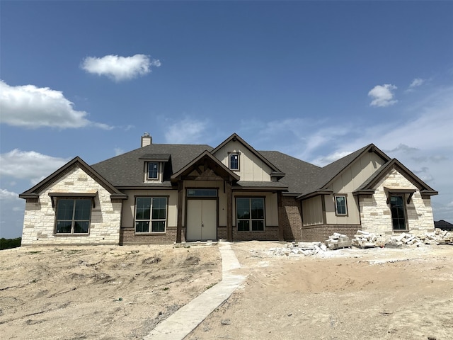 150 Waterview, Gunter, TX 75058 - view of front of home with a chimney, stone siding, a shingled roof, board and batten siding, and brick siding