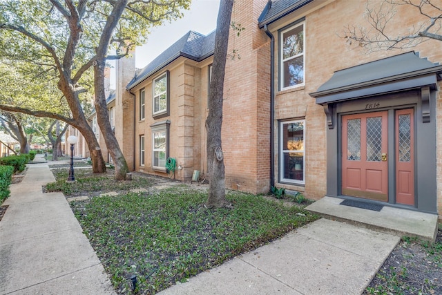 7814 Meadow Park Dr Unit 219, Dallas, TX 75230 - property entrance featuring brick siding and a chimney
