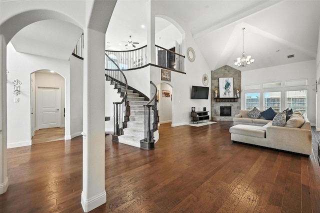 9840 El Colina Dr, Fort Worth, TX 76179 - living room with high vaulted ceiling, ceiling fan, arched walkways, stairs, and a large fireplace