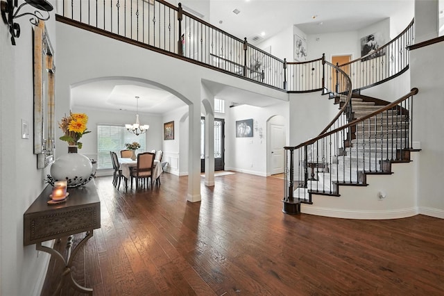 9840 El Colina Dr, Fort Worth, TX 76179 - entryway with arched walkways, a high ceiling, hardwood / wood-style flooring, stairway, and a chandelier