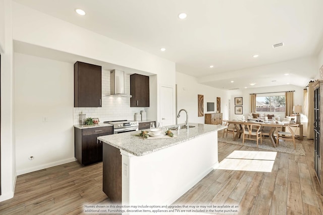 115 Wild Oak Gln, Lavon, TX 75166 - kitchen with wall chimney exhaust hood, electric stove, dark brown cabinets, light wood-style floors, and recessed lighting
