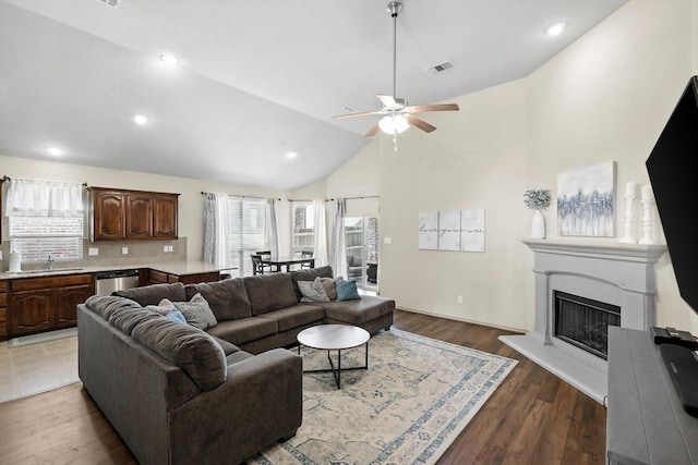 10200 Wildfowl Dr, Fort Worth, TX 76177 - living area with a ceiling fan, light wood-style flooring, a fireplace with raised hearth, high vaulted ceiling, and recessed lighting