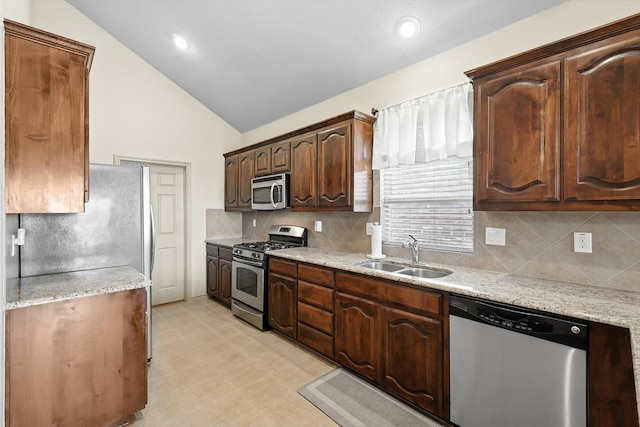 10200 Wildfowl Dr, Fort Worth, TX 76177 - kitchen with appliances with stainless steel finishes, tasteful backsplash, dark brown cabinetry, light stone counters, and recessed lighting
