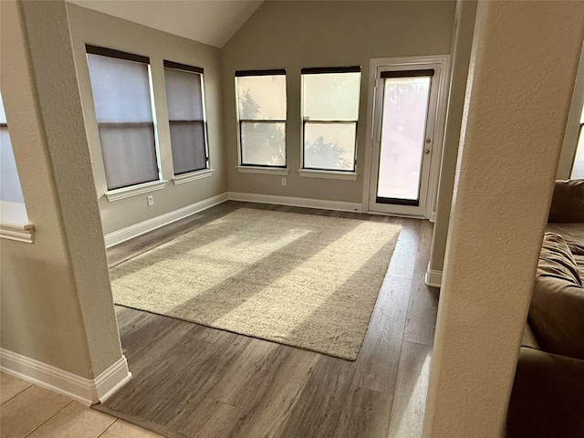 12713 Travers Trl, Fort Worth, TX 76244 - unfurnished room featuring lofted ceiling, wood finished floors, and a textured wall