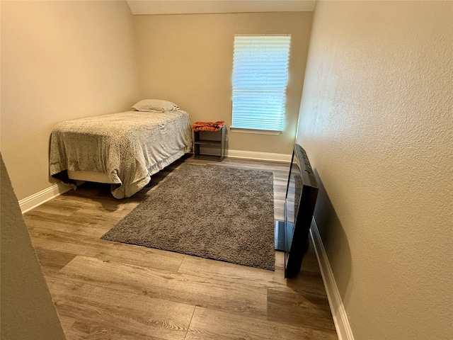 12713 Travers Trl, Fort Worth, TX 76244 - bedroom featuring wood finished floors and a textured wall