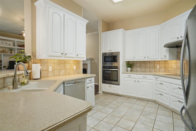 1660 Spinnaker Ln, Azle, TX 76020 - kitchen featuring stainless steel appliances, tasteful backsplash, light tile patterned flooring, under cabinet range hood, and white cabinetry
