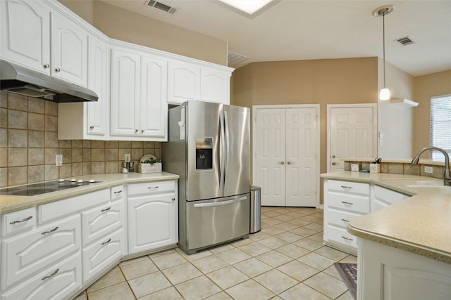 1660 Spinnaker Ln, Azle, TX 76020 - kitchen with stainless steel refrigerator with ice dispenser, black electric stovetop, under cabinet range hood, tasteful backsplash, and pendant lighting