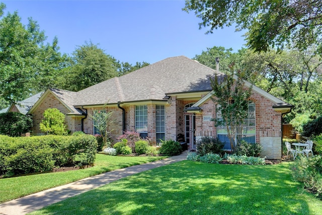 1660 Spinnaker Ln, Azle, TX 76020 - french country inspired facade with brick siding, roof with shingles, and a front yard