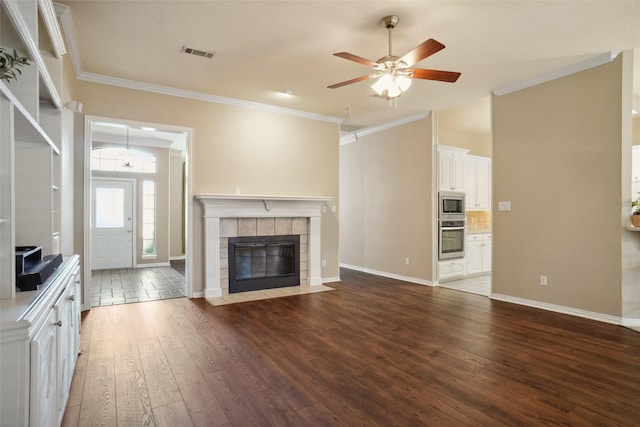 1660 Spinnaker Ln, Azle, TX 76020 - unfurnished living room featuring wood-type flooring, a ceiling fan, ornamental molding, and a tiled fireplace