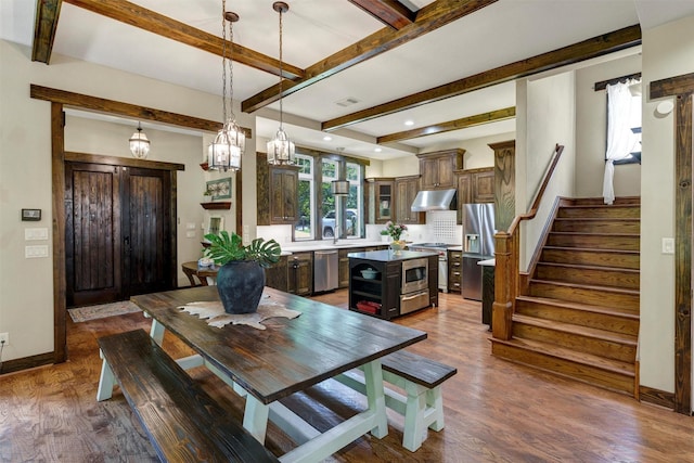 421 Dallas St, Argyle, TX 76226 - dining area with dark wood finished floors, beamed ceiling, stairway, recessed lighting, and a chandelier