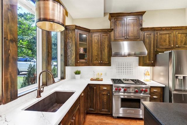 421 Dallas St, Argyle, TX 76226 - kitchen featuring appliances with stainless steel finishes, range hood, plenty of natural light, and tasteful backsplash