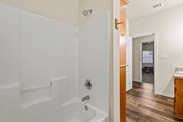 105 William St, Pottsboro, TX 75076 - bathroom with vanity, washtub / shower combination, and wood finished floors