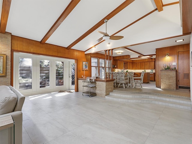 1102 N Graves St, Mckinney, TX 75069 - tiled living area featuring french doors, wooden walls, beamed ceiling, a ceiling fan, and high vaulted ceiling