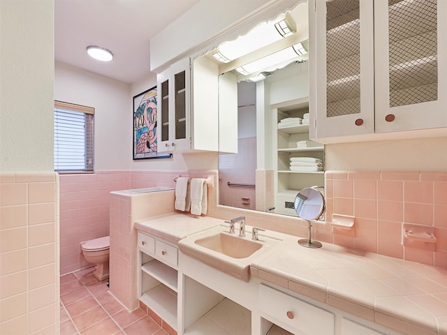 1102 N Graves St, Mckinney, TX 75069 - bathroom with tile patterned flooring, tile walls, vanity, and wainscoting