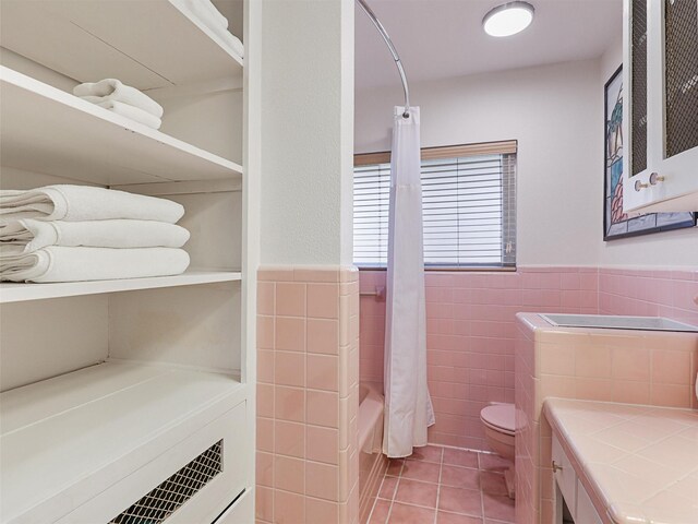 1102 N Graves St, Mckinney, TX 75069 - bathroom featuring tile patterned floors, tile walls, shower / tub combo, a wainscoted wall, and vanity